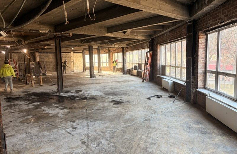 The raw floor plate before work started, columns and windows exposed